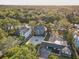Stunning aerial view of a beautiful home nestled among lush trees, bordering a tranquil river at 7500 N Ola Ave, Tampa, FL 33604