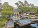 Expansive backyard deck overlooking the water with a boat lift, gazebo, and seating at 7500 N Ola Ave, Tampa, FL 33604