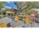 Spacious backyard deck with colorful seating, a decorative flamingo, and serene water views at 7500 N Ola Ave, Tampa, FL 33604