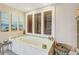 Relaxing bathroom with a soaking tub, custom shutters, and serene decor at 7500 N Ola Ave, Tampa, FL 33604