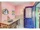 Charming pink nautical bathroom showcases unique vanity, porthole mirror, and seaside artwork at 7500 N Ola Ave, Tampa, FL 33604