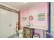 Pink nautical bathroom features unique vanity, porthole mirror, and quirky seaside charm at 7500 N Ola Ave, Tampa, FL 33604