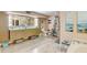 Bright bathroom features a double vanity with modern countertop, a separate toilet, and artwork at 7500 N Ola Ave, Tampa, FL 33604