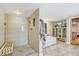 Spa-like bathroom features a tiled shower, soaking tub, and elegant decor at 7500 N Ola Ave, Tampa, FL 33604