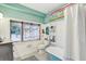 Well-lit bathroom includes a vintage-style tub and a window with decorative curtains at 7500 N Ola Ave, Tampa, FL 33604