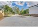 A large circular driveway is surrounded by lush landscaping, offering plenty of parking and a welcoming entrance at 7500 N Ola Ave, Tampa, FL 33604