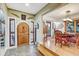 Grand entryway with a wooden front door, stained glass and view to dining area at 7500 N Ola Ave, Tampa, FL 33604