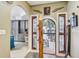 Entryway leading to the kitchen with stained-glass doors and charming decor at 7500 N Ola Ave, Tampa, FL 33604