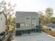 Beautiful three-story home featuring neutral siding, white trim, and an elevated design at 7500 N Ola Ave, Tampa, FL 33604