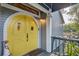 Charming yellow front door with unique details and a welcoming entrance area at 7500 N Ola Ave, Tampa, FL 33604