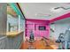 Home gym boasts ample workout equipment, with pink walls, for fitness enthusiasts at 7500 N Ola Ave, Tampa, FL 33604