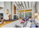 Cozy living room with high ceilings, a fireplace, and sliding doors to the deck at 7500 N Ola Ave, Tampa, FL 33604