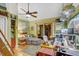 Bright, organized office space with wood floors, ceiling fan and a sectional couch for relaxing at 7500 N Ola Ave, Tampa, FL 33604