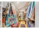 Organized walk-in closet with ample storage, colorful decor, and a full-length mirror at 7500 N Ola Ave, Tampa, FL 33604