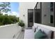 Cozy balcony with outdoor seating, stylish decor, and views of the surrounding lush greenery at 7608 Antilla St, Tampa, FL 33625