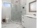 A bright modern bathroom boasts sleek tiled floors, a large glass shower, and contemporary fixtures at 7608 Antilla St, Tampa, FL 33625