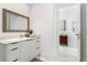 Bright bathroom featuring a large vanity, modern fixtures, and sleek tiled flooring at 7608 Antilla St, Tampa, FL 33625