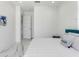 Modern bedroom with white walls, marble floors, and a cozy bed with seaside throw pillows at 7608 Antilla St, Tampa, FL 33625