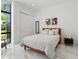 Bright bedroom with modern decor, stylish furniture, and sleek tiled floors at 7608 Antilla St, Tampa, FL 33625