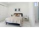 Bedroom with modern decor, stylish furniture, and sleek tiled floors, white doors, and lots of natural light at 7608 Antilla St, Tampa, FL 33625