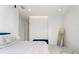 Serene bedroom featuring a king-size bed, large mirror, and abundant natural light, creating a tranquil retreat at 7608 Antilla St, Tampa, FL 33625