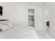 Bright bedroom view to bathroom with sleek tiled floors and modern white doors at 7608 Antilla St, Tampa, FL 33625