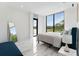 Bright bedroom with large windows offering scenic views, complemented by elegant furnishings and modern decor at 7608 Antilla St, Tampa, FL 33625