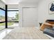 Bedroom featuring modern decor, stylish furniture, sleek tiled floors, and large picture window at 7608 Antilla St, Tampa, FL 33625