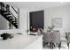 Open-concept dining and living area showcasing modern design, dark accent wall, and staircase detail at 7608 Antilla St, Tampa, FL 33625