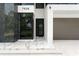 Modern home entrance with marble accents, stylish door, and lush landscaping creating curb appeal at 7608 Antilla St, Tampa, FL 33625