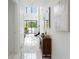 Modern hallway with marble floors, high ceilings, and a view of the backyard pool area at 7608 Antilla St, Tampa, FL 33625