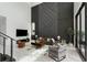 View of the living room with accent wall and an abundance of natural light at 7608 Antilla St, Tampa, FL 33625