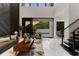 Open-concept living room with marble floors, modern decor, and a seamless connection to the outdoor pool area at 7608 Antilla St, Tampa, FL 33625