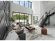 Open-concept living room with modern decor, marble floors, and a view of the backyard pool area at 7608 Antilla St, Tampa, FL 33625