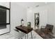 Bright home office featuring modern desk, decor, and comfortable gray chair with elegant marble floors at 7608 Antilla St, Tampa, FL 33625