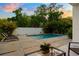 Beautiful pool area with modern pavers, lush landscaping, and comfortable lounge chairs at 7608 Antilla St, Tampa, FL 33625