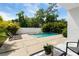 Backyard pool area featuring chaise lounges, patio and lush tropical landscaping around the perimeter at 7608 Antilla St, Tampa, FL 33625