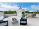 Stylish rooftop deck featuring comfortable seating, a modern fire pit, and a dining area at 7608 Antilla St, Tampa, FL 33625
