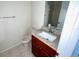 Cozy bathroom featuring a granite vanity top, wood cabinet, toilet, and a large mirror at 8608 Twin Farms Pl, Tampa, FL 33635