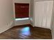 Bedroom with wood-look flooring, large window, and closet at 8608 Twin Farms Pl, Tampa, FL 33635