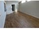 Open-concept living area with wood-look tile flooring and ample natural light at 8608 Twin Farms Pl, Tampa, FL 33635