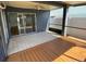Covered lanai featuring both tiled and wood flooring, perfect for outdoor living at 8608 Twin Farms Pl, Tampa, FL 33635