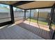 Screened-in patio with tile and wood flooring for relaxing or entertaining at 8608 Twin Farms Pl, Tampa, FL 33635