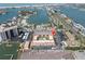 Aerial view of waterfront property with marina, pool, parking, and bay access to the ocean at 10365 Paradise Blvd # 4, Treasure Island, FL 33706