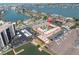 Aerial view of building with pool and nearby docks, water, and surrounding buildings and roadways at 10365 Paradise Blvd # 4, Treasure Island, FL 33706