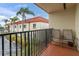 Balcony with chairs overlooking the complex and palm trees at 10365 Paradise Blvd # 4, Treasure Island, FL 33706