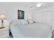 Bedroom with light blue bedding, bedside tables, and a closet at 10365 Paradise Blvd # 4, Treasure Island, FL 33706