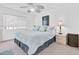 Bedroom with light blue bedding, ceiling fan, and window at 10365 Paradise Blvd # 4, Treasure Island, FL 33706