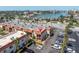 Exterior view of building featuring parking, balconies, and manicured landscaping at 10365 Paradise Blvd # 4, Treasure Island, FL 33706