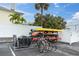 Community kayak storage with kayak racks and bikes, surrounded by lush tropical landscaping at 10365 Paradise Blvd # 4, Treasure Island, FL 33706
